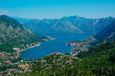 High angle view of townscape by sea against sky