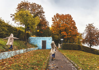 Multiple image of woman enjoying at park during autumn