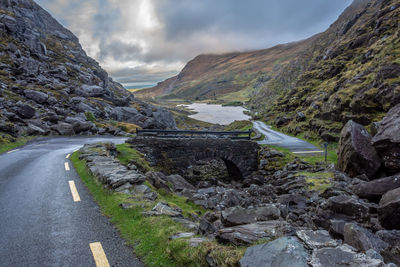 Road amidst rocks against sky