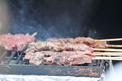 Close-up of meat on barbecue grill