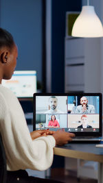 Woman doing video call with colleagues on laptop