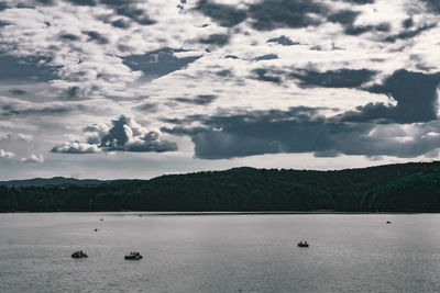 Scenic view of sea and mountains against sky