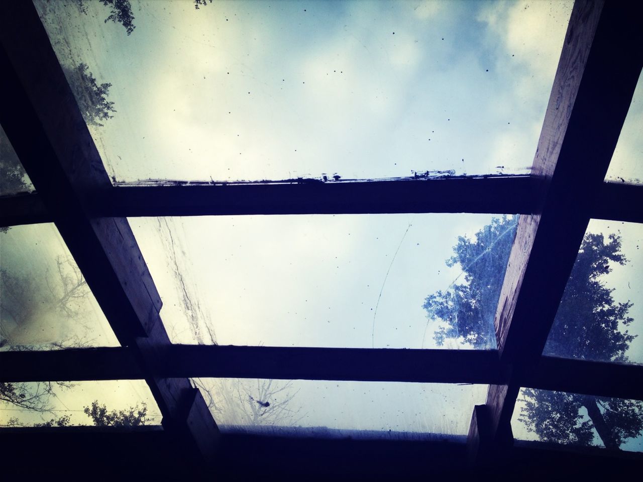 sky, window, indoors, cloud - sky, glass - material, low angle view, built structure, cloud, transparent, day, cloudy, railing, architecture, no people, nature, fence, glass, metal, wall