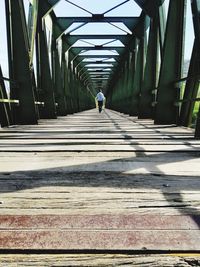 Rear view of man walking in tunnel