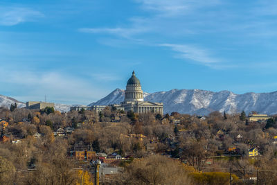 Panoramic view of buildings and mountains against sky