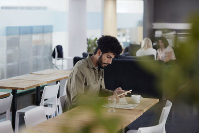 Man working solitary in office cafeteria