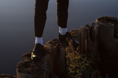 Low section of person standing on cliff