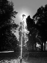 Low angle view of fountain in park against sky