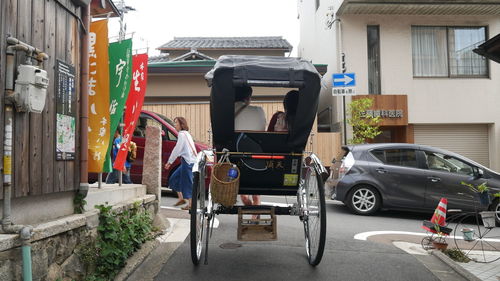 Pedicab on street by houses