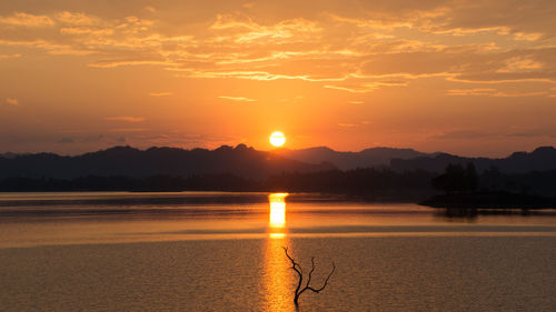 Scenic view of lake against sky during sunset