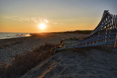 Scenic view of beach against sky during sunset