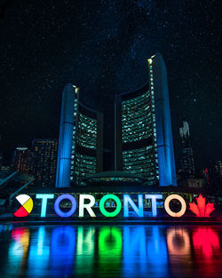 Illuminated building against sky at night