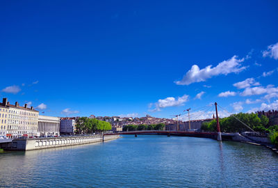 Bridge over river against blue sky