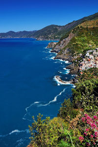 High angle view of sea by cinque terre against clear blue sky