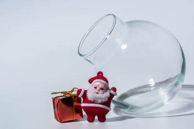 Christmas decoration and glass container over white background