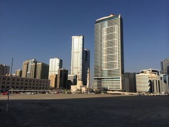 Modern buildings against clear blue sky