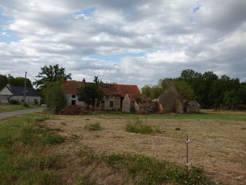 Houses on field against sky
