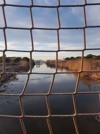 Scenic view of lake against sky seen through window