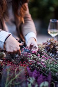 Midsection of woman cutting plants