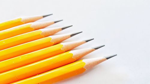 Close-up of multi colored pencils against white background