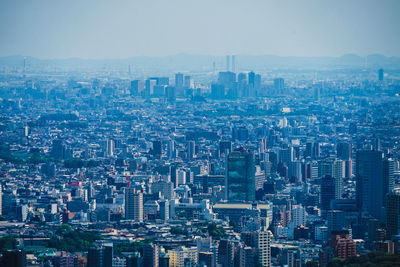 High angle view of modern buildings in city against sky