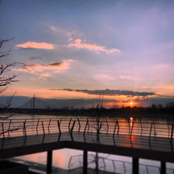 Scenic view of lake against orange sky