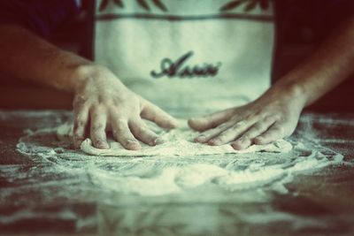 Close-up of person preparing food on table