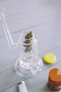 Close-up of water bong and marijuana on table