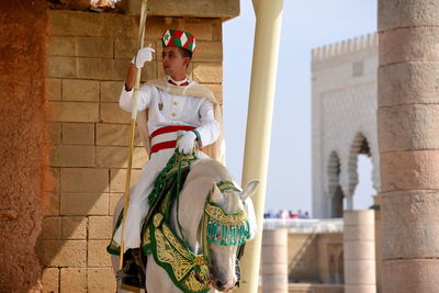 Full length of man standing against wall