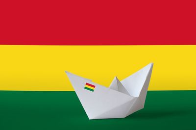 Close-up of paper flag against yellow background