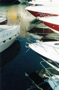 High angle view of sailboats moored at harbor