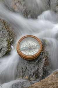 Close-up of clock on rock