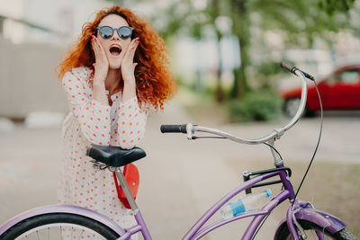Woman wearing sunglasses on bicycle