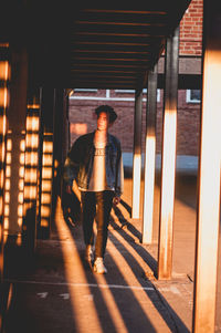 Rear view of man walking in corridor of building