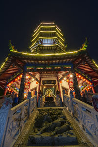 Low angle view of illuminated building at night