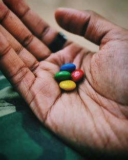 Close-up of hand holding colorful candies