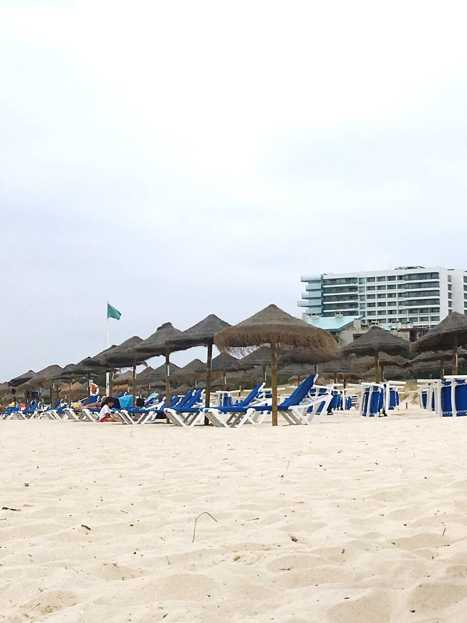 LOUNGE CHAIRS AND PARASOLS ON BEACH