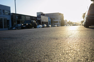 Cars on road in city against sky