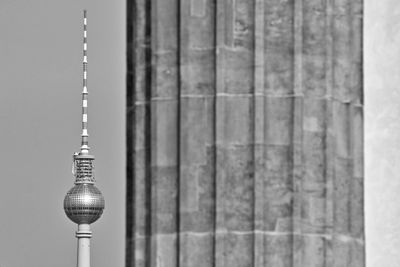 Communications tower against sky in city