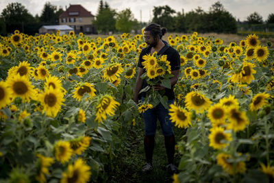 Full length of sunflower standing on field