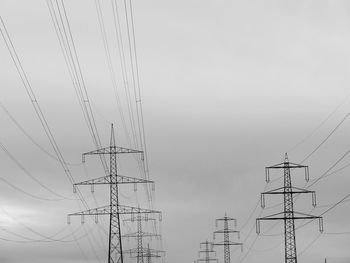 Low angle view of electricity pylon against sky