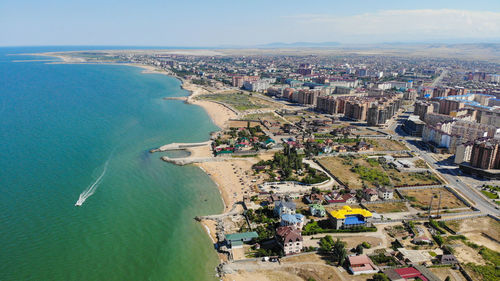 High angle view of buildings and sea against sky