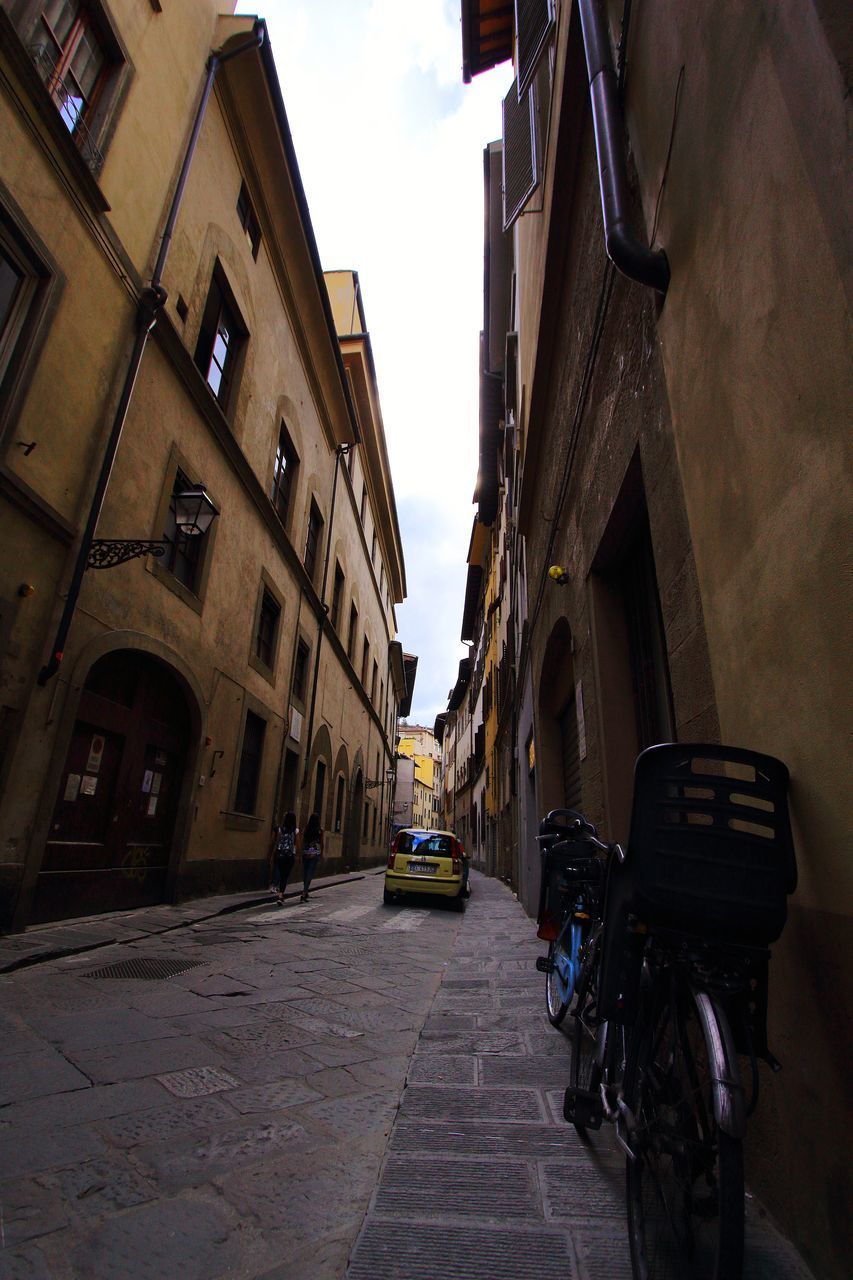 STREET AMIDST BUILDINGS AGAINST SKY