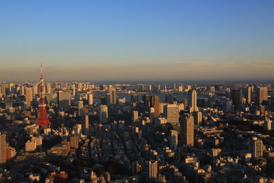 High angle view of city buildings against sky during sunset