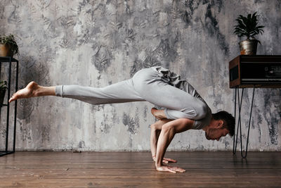 A man with strong body engaged in yoga and meditation, performing asanas