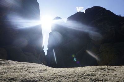 Sunlight streaming through rocks on sunny day