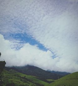 Scenic view of landscape against cloudy sky