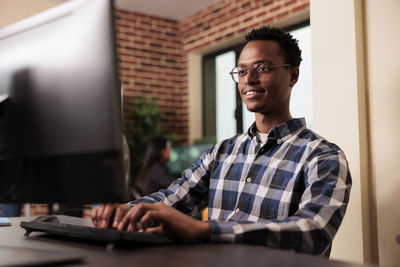 Young man using laptop at table