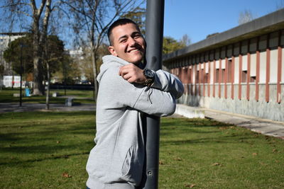 Portrait of a smiling young man standing outdoors