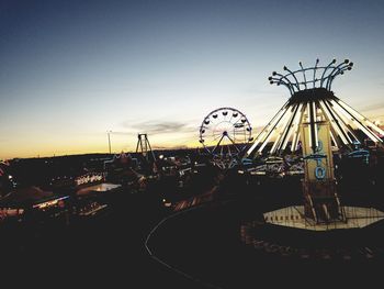 Ferris wheel against sky at sunset